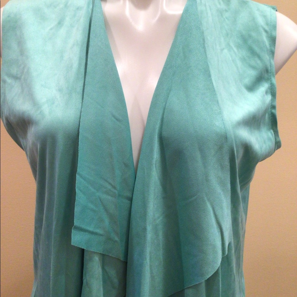 Mirror image sleeveless open front cardigan